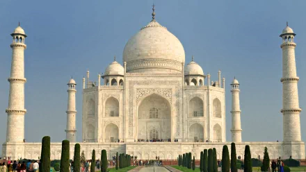 HD desktop wallpaper featuring the magnificent Taj Mahal, a stunning example of man-made architecture, with its iconic marble dome and symmetrical gardens under a clear blue sky.