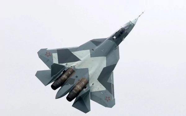 A Sukhoi Su-57 military jet soaring through the sky, showcasing its sleek design and advanced technology, captured in high-definition for a striking desktop wallpaper.