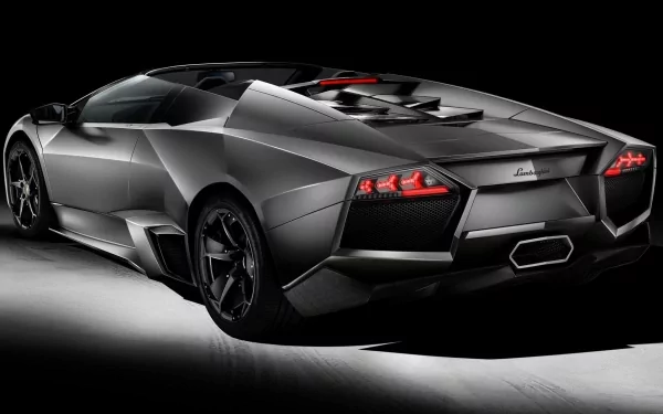 HD PC desktop wallpaper showcasing a sleek, matte black Lamborghini Reventon sports car from the rear-angle view against a dark background.