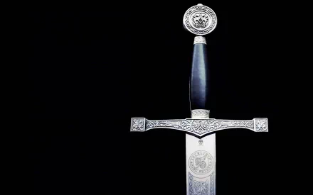 HD PC desktop wallpaper featuring a detailed man-made sword with ornate engravings on the hilt and blade set against a black background.