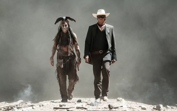 Armie Hammer as Tonto and Johnny Depp as the Lone Ranger walk together through a dramatic, smoky landscape in this HD desktop wallpaper from The Lone Ranger.