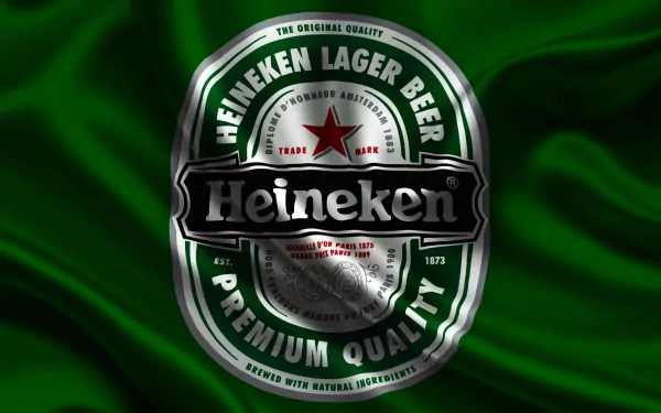 Man-made Heineken lager beer badge with red star on rippling green fabric — 2K Quad HD PC desktop wallpaper and background.