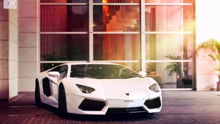 A sleek white Lamborghini Aventador LP 700-4 parked in front of a modern building, showcasing its striking design and luxurious appeal in this stunning HD wallpaper.