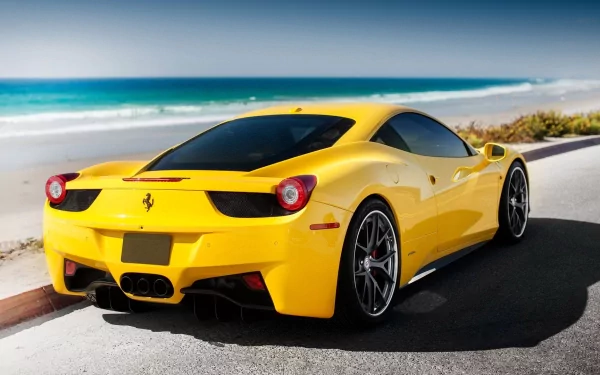 A stunning yellow Ferrari 458 Italia parked along a scenic beach road, captured in high definition, showcasing its sleek design against a vibrant coastal backdrop.