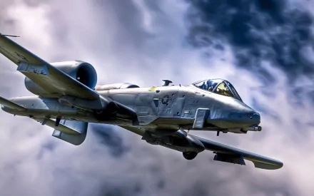 Fairchild Republic A-10 Thunderbolt II in flight against dramatic clouds — military HD PC desktop wallpaper and background.