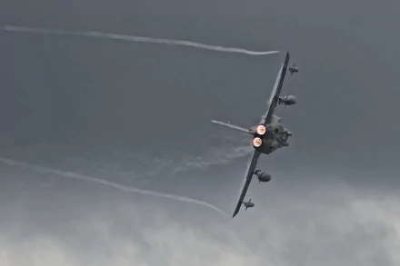 HD desktop wallpaper featuring a Panavia Tornado military aircraft in flight with afterburners engaged against a cloudy sky background.