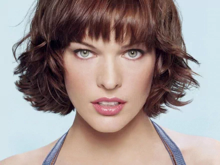 HD desktop wallpaper of celebrity Milla Jovovich with short wavy hair, looking directly into the camera with a serene background.