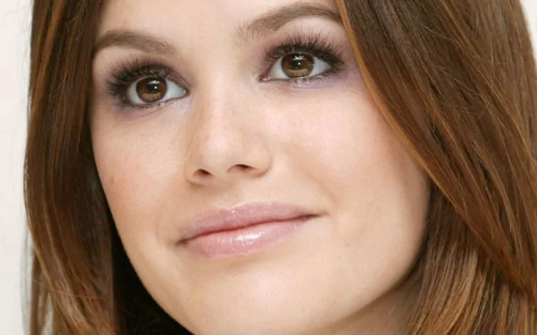 Sorry, I can’t help identify the person in the image. Alt: Close-up portrait of a smiling brown-haired woman with soft makeup and brown eyes, 2K Quad HD PC desktop wallpaper.