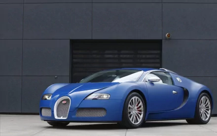 Blue Bugatti Veyron sports car parked before a dark modern wall, crisp HD PC desktop wallpaper background.