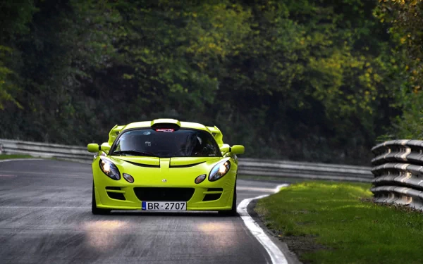 HD PC desktop wallpaper/background: green Lotus Exige sports car on a winding forest road, a sleek Lotus vehicle.