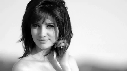 Black and white HD desktop wallpaper featuring celebrity Susan Coffey with a soft smile, looking directly at the camera against a blurred background.