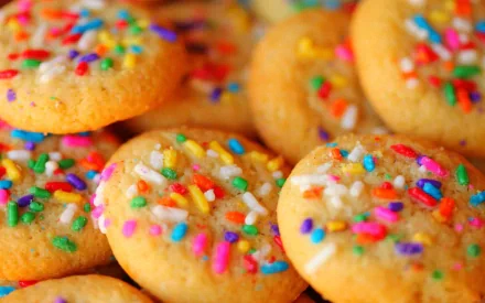 Close-up HD desktop wallpaper of colorful sprinkle-topped cookies showcasing vibrant hues and delicious texture.