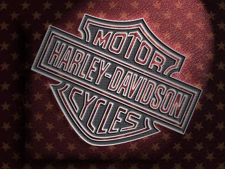 Harley-Davidson logo embossed on a textured background, featured as an HD PC desktop wallpaper showcasing the iconic motorcycle brand.