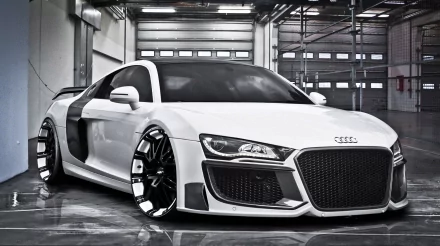 HD desktop wallpaper and background featuring a sleek white Audi R8 in a modern garage setting, showcasing its bold and stylish design.