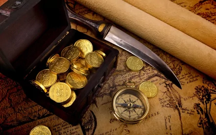 A treasure chest overflowing with gold coins sits next to a compass and a dagger, set against an antique map background, creating a captivating man-made gold theme.