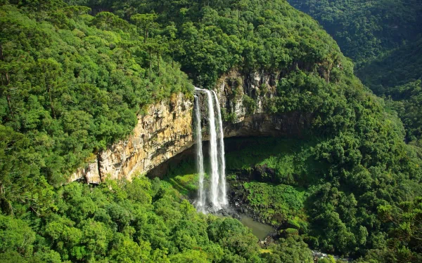 Lush green valley with Caracol Falls cascading from a cliff into a pool; panoramic nature scene rendered as a 2K Quad HD PC desktop wallpaper and background.