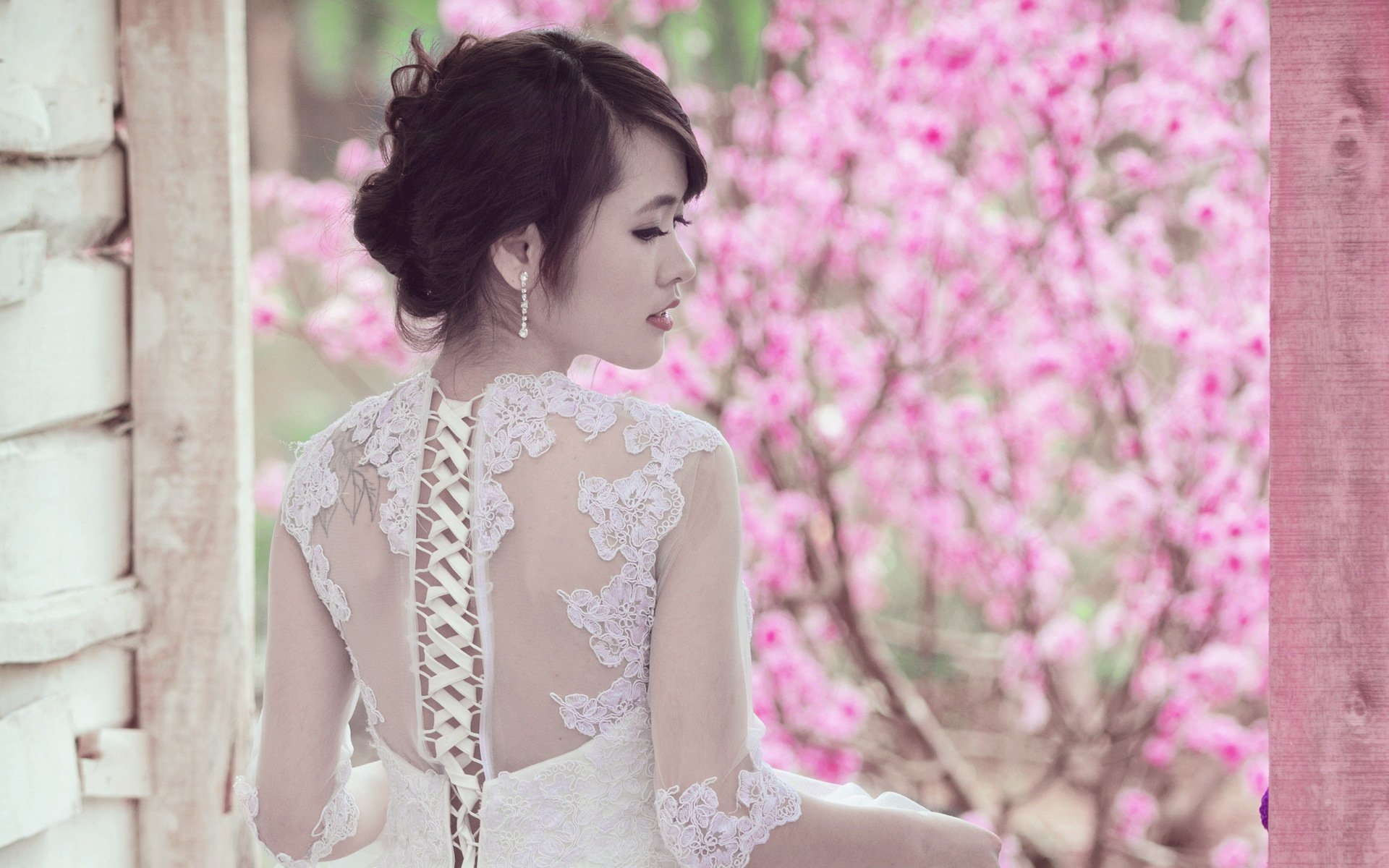 HD desktop wallpaper of an Asian woman in a lace dress standing against a backdrop of vibrant pink flowers.
