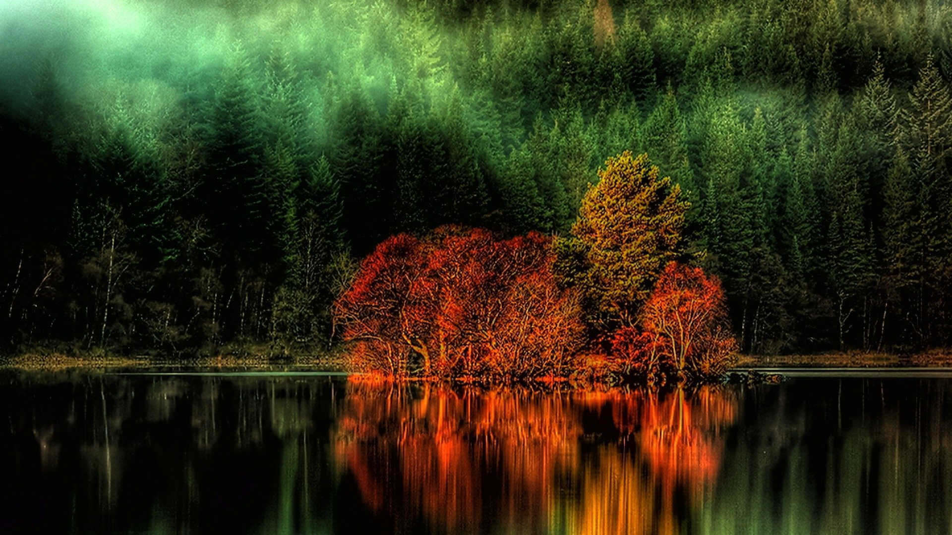 HD PC desktop wallpaper and background showing vibrant orange trees mirrored in a glassy lake before a misty green conifer forest — nature reflection.