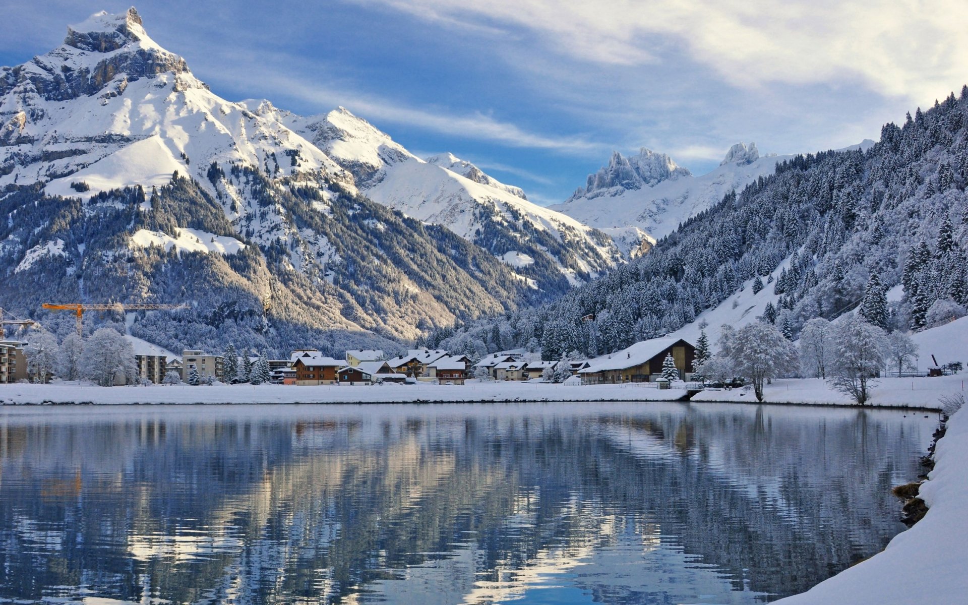 HD winter photography showcasing a serene snow-covered mountain landscape reflected in a calm lake, designed as a PC desktop wallpaper and background.