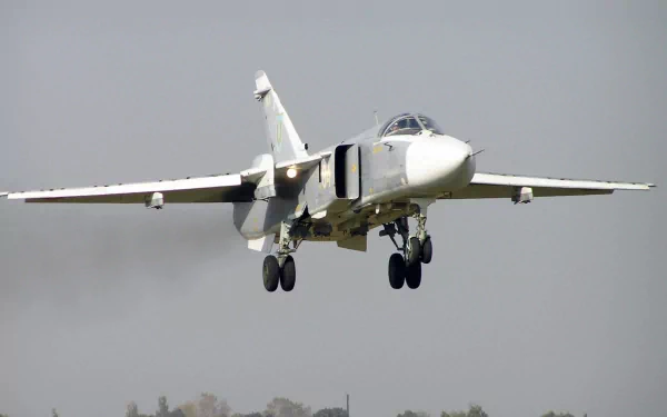 HD desktop wallpaper featuring a close-up of a military aircraft in flight, showcasing its landing gear and wings against a clear sky background.