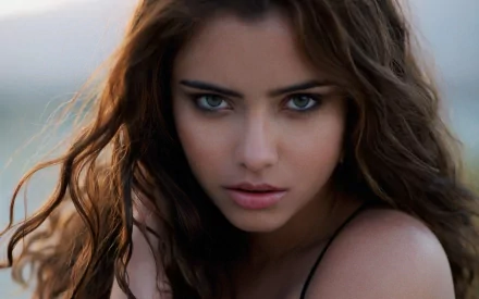 A captivating portrait of Nataniele Ribeiro, a Brazilian model, showcasing her intense stare and striking features. This high-definition image serves as a stunning desktop wallpaper.