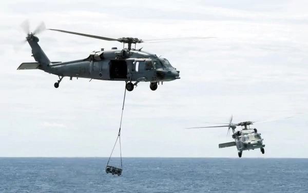 HD desktop wallpaper featuring a Sikorsky MH-60S Sea Hawk helicopter of the Navy Marines carrying cargo over the ocean, showcasing military aircraft and vehicles.