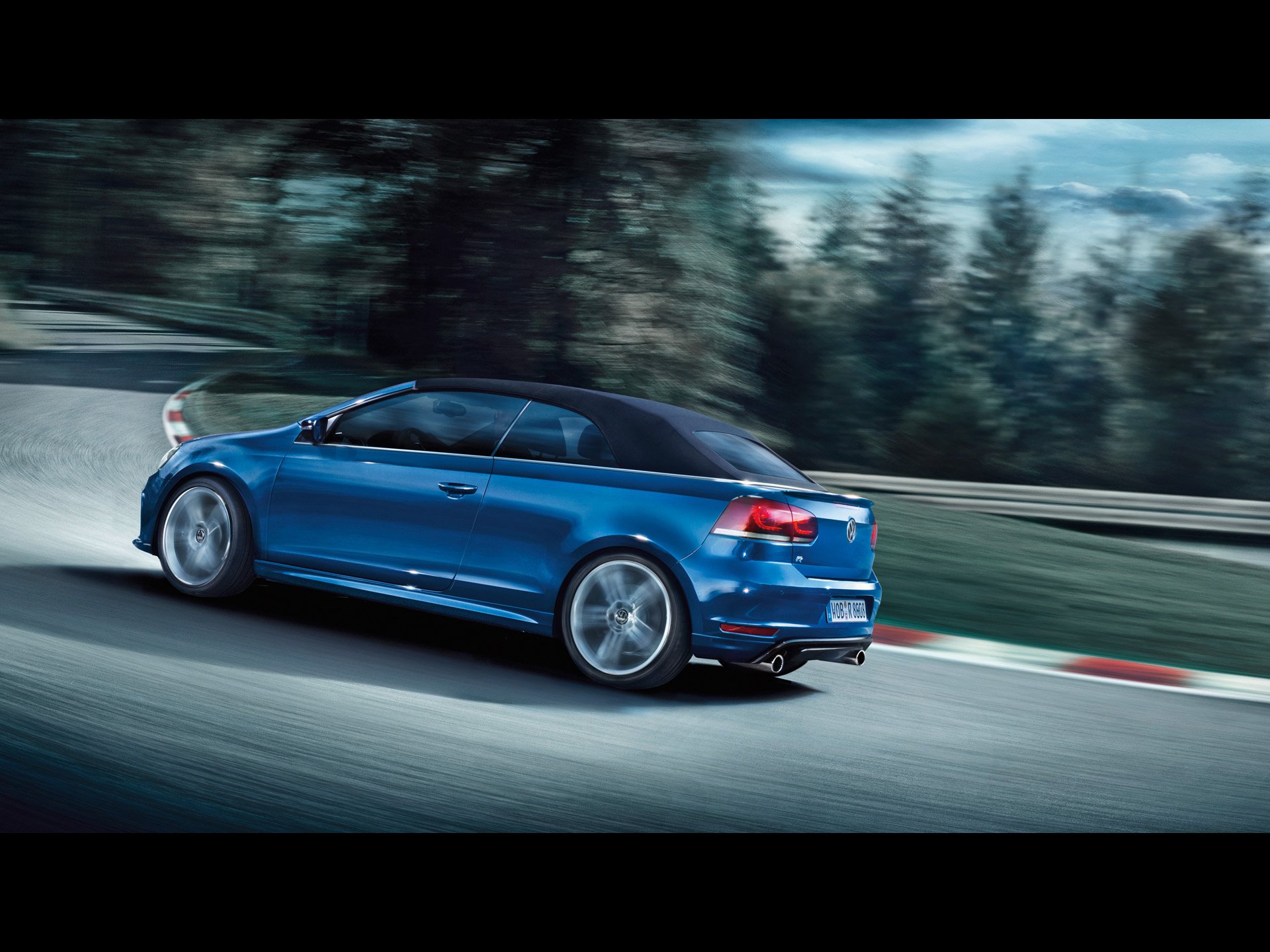 Blue 2013 Volkswagen Golf R Cabriolet speeding on a racetrack, captured in HD for a dynamic desktop wallpaper background.