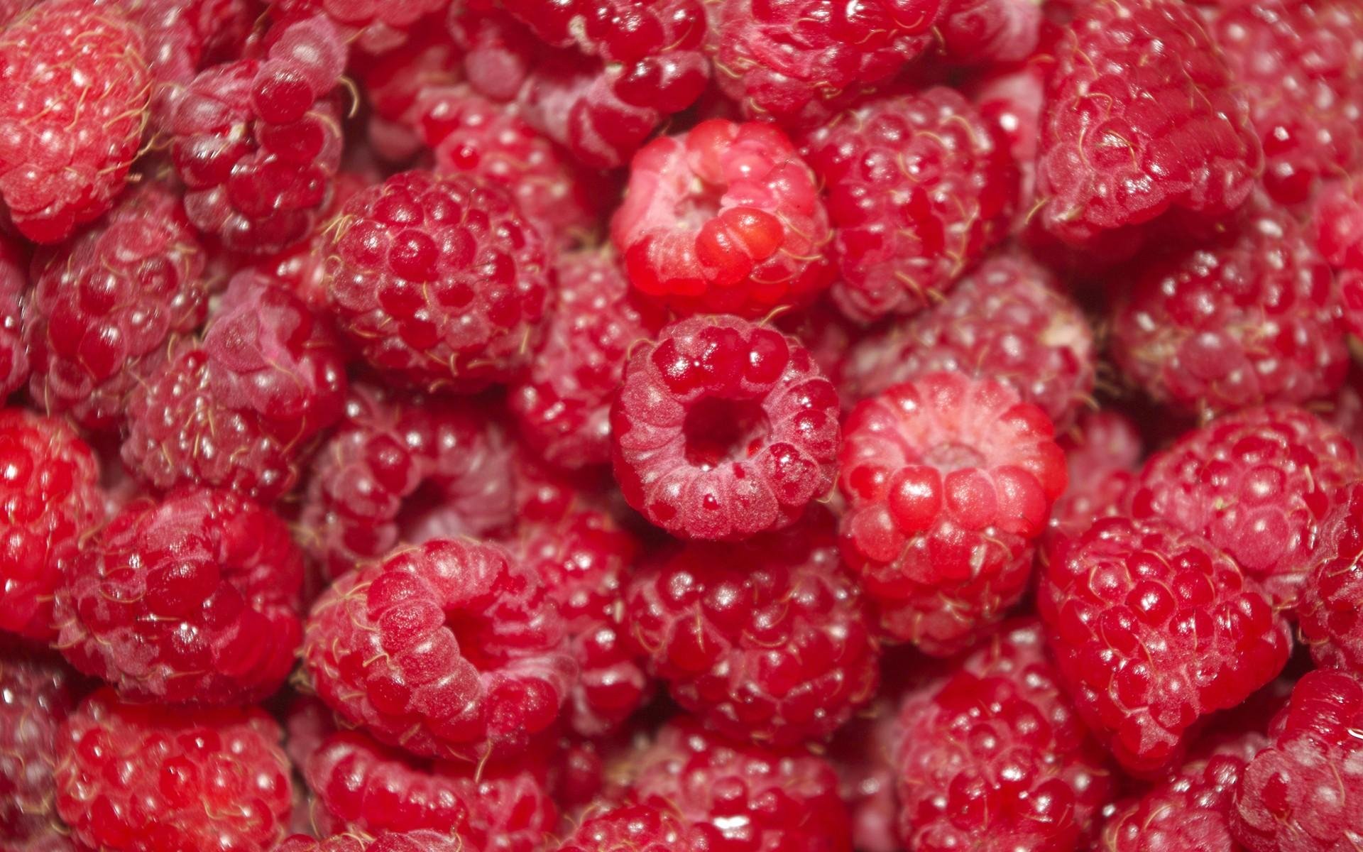HD PC desktop wallpaper — close-up of glossy red raspberries filling the frame, vivid food texture.