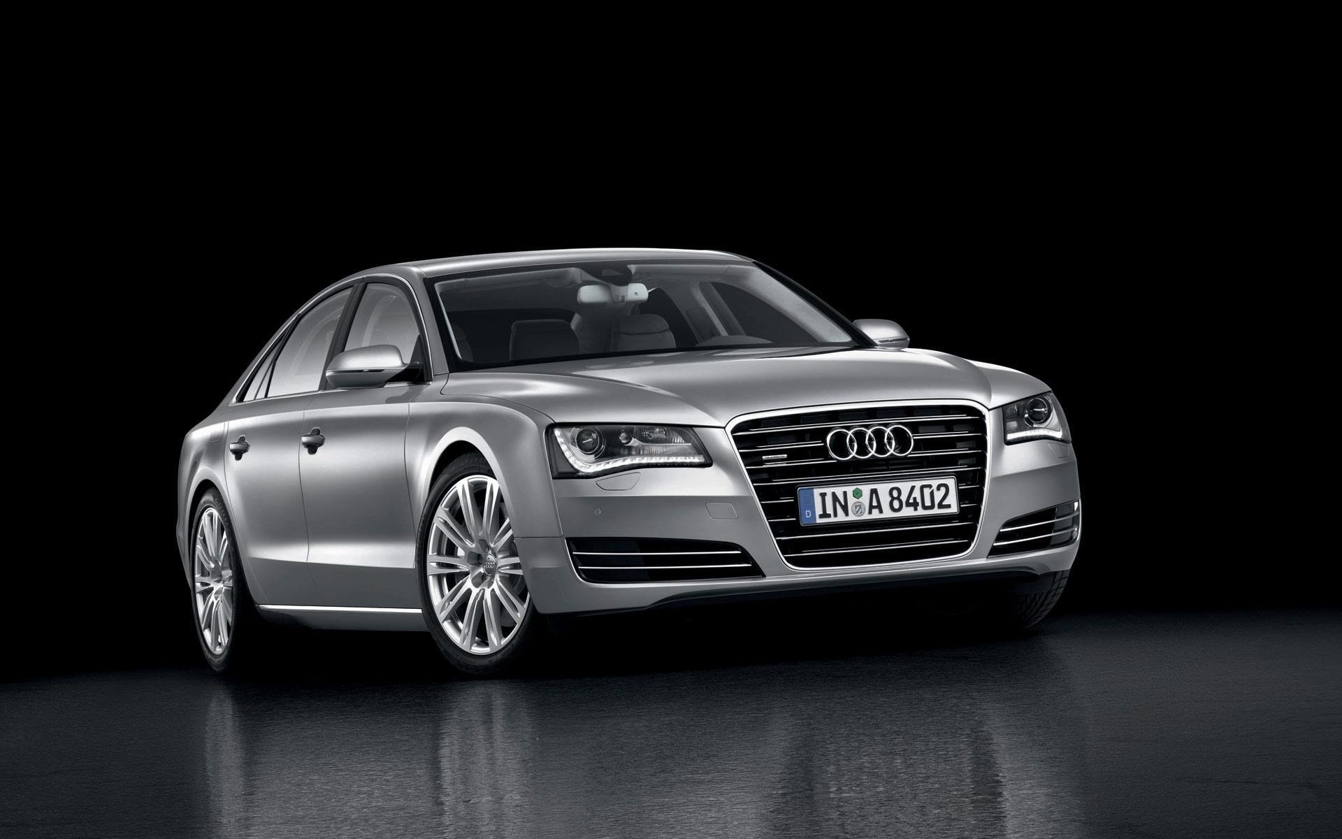 Silver Audi A8 sedan, three-quarter front view on a reflective black surface — HD PC desktop wallpaper and background.