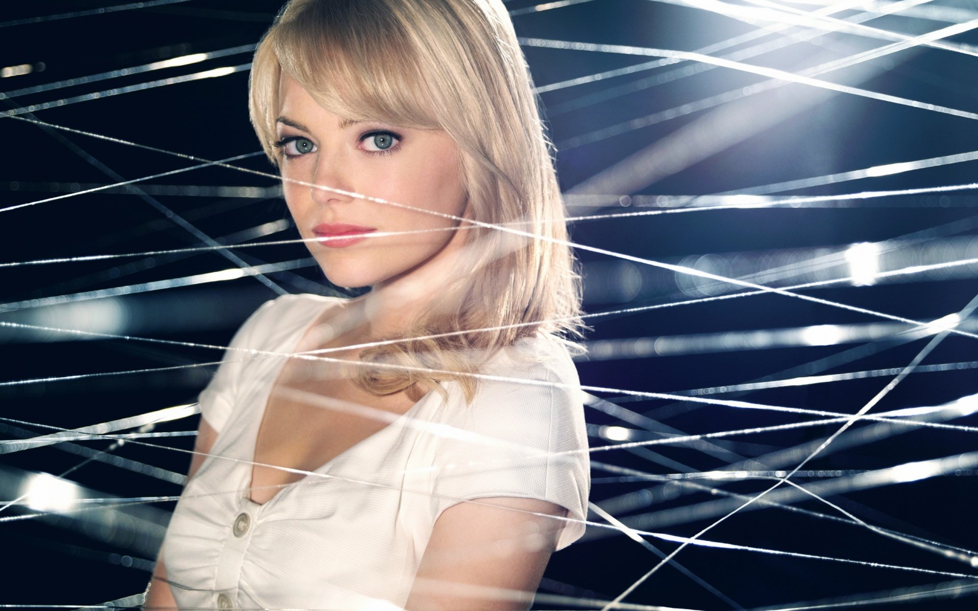 A striking HD desktop wallpaper featuring celebrity Emma Stone, captured against a backdrop of shimmering light and delicate lines, creating an intriguing visual appeal.