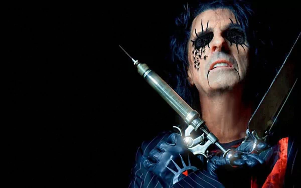 HD PC desktop wallpaper featuring rock musician Alice Cooper with dramatic makeup and theatrical props against a dark background.
