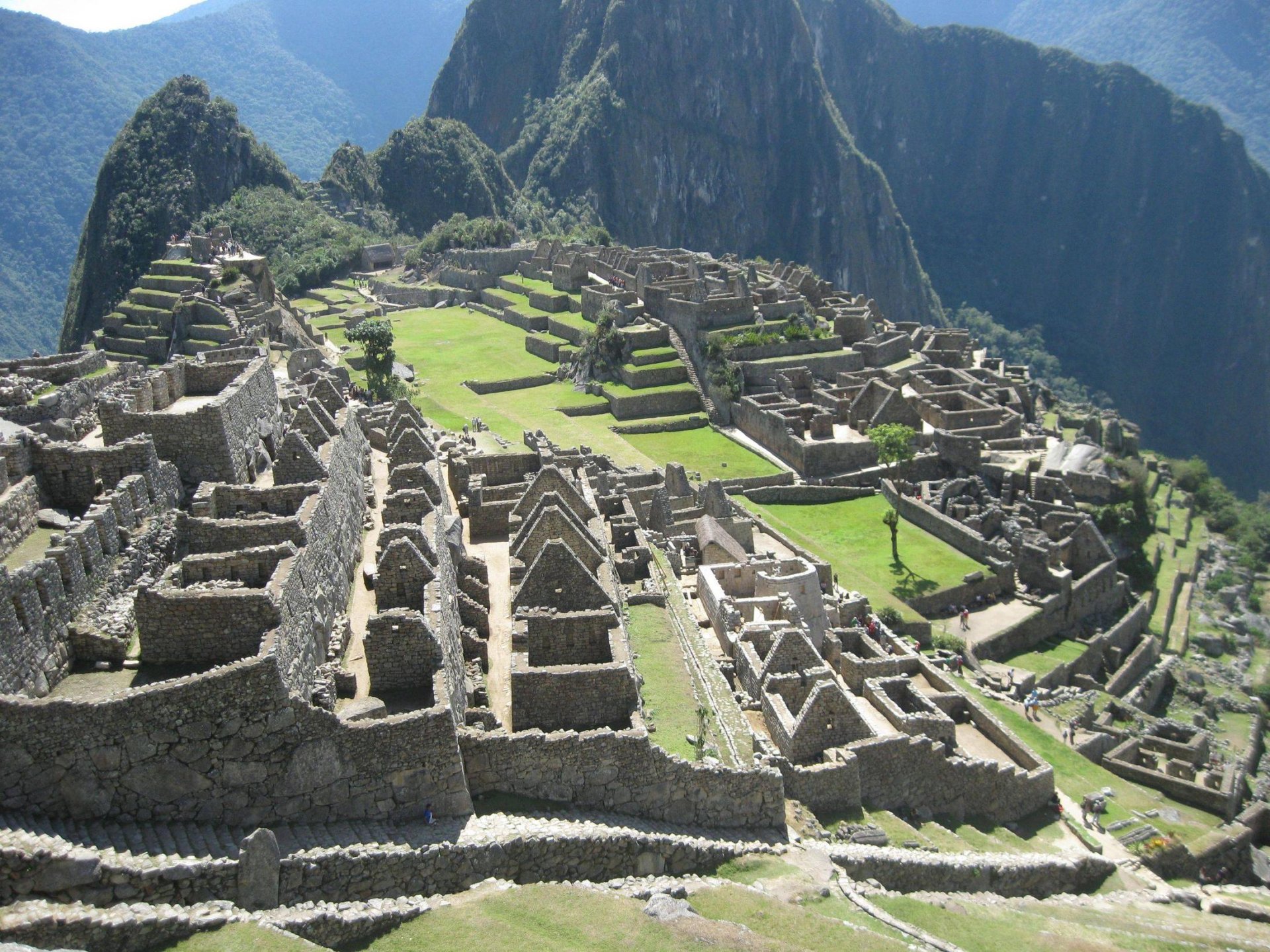 HD desktop wallpaper featuring the man-made ancient ruins of Machu Picchu nestled among lush mountainous terrain.