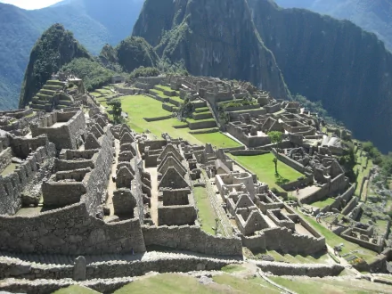 HD desktop wallpaper featuring the man-made ancient ruins of Machu Picchu nestled among lush mountainous terrain.