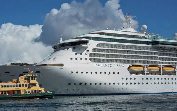 Radiance of the Seas cruise ship in Sydney, Australia harbor, a yellow ferry passing in the foreground under a blue sky — HD PC desktop wallpaper.