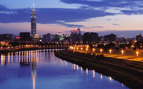 HD desktop wallpaper showcasing Taipei's skyline at dusk with illuminated buildings and Taipei 101 tower reflecting on the river.