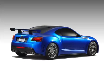 A sleek blue Subaru BRZ, showcasing its aerodynamic design and sporty rear wing, serves as an eye-catching HD desktop wallpaper and background.
