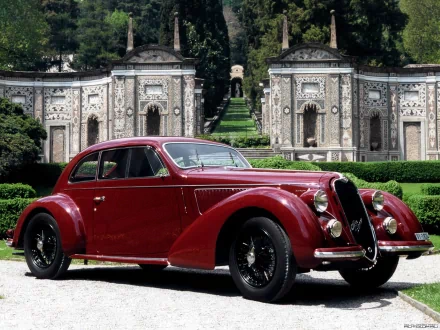 A classic red Alfa Romeo 6C 2300 parked in front of an ornate garden pavilion, featured as a HD PC desktop wallpaper and background.