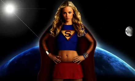 A blonde Supergirl stands confidently in a blue top and red skirt against a cosmic background featuring the sun, moon, and planets, embodying strength and adventure in this vibrant HD wallpaper.