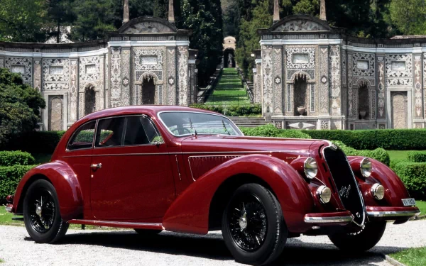 A classic red Alfa Romeo 6C 2300 parked in front of an ornate garden pavilion, featured as a HD PC desktop wallpaper and background.