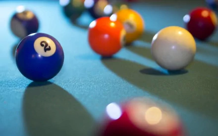 HD PC desktop wallpaper featuring a close-up of colorful billiard balls on a pool table, highlighting the game’s vibrant and dynamic atmosphere.