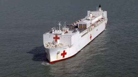 Aerial view of USNS Comfort (T-AH-20), U.S. Navy hospital ship with red crosses — military naval medical vessel at sea, 2K Quad HD desktop wallpaper.