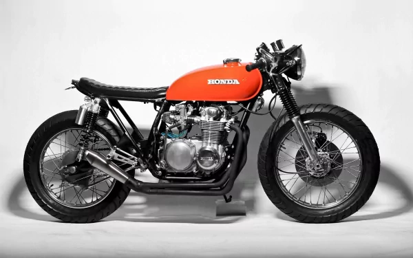 HD PC desktop wallpaper featuring a classic orange Honda CB500 motorcycle against a clean white background.