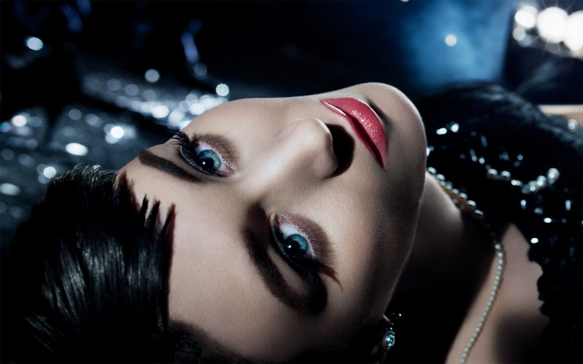 A striking HD wallpaper featuring Rooney Mara, showcasing her captivating gaze and elegant look against a shimmering backdrop.
