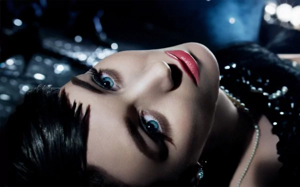 A striking HD wallpaper featuring Rooney Mara, showcasing her captivating gaze and elegant look against a shimmering backdrop.