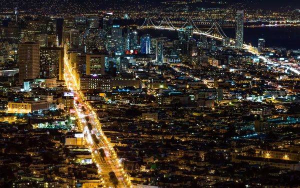 A stunning HD view of San Francisco at night, showcasing a vibrant cityscape with illuminated streets and iconic landmarks against a dark sky.