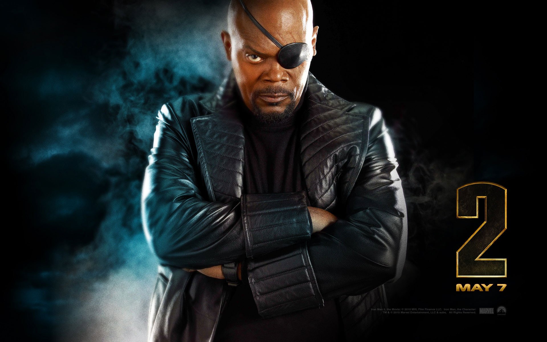 HD desktop wallpaper featuring Samuel L. Jackson as Nick Fury from the movie Iron Man 2, with a dark smoky background and the release date May 7 displayed.