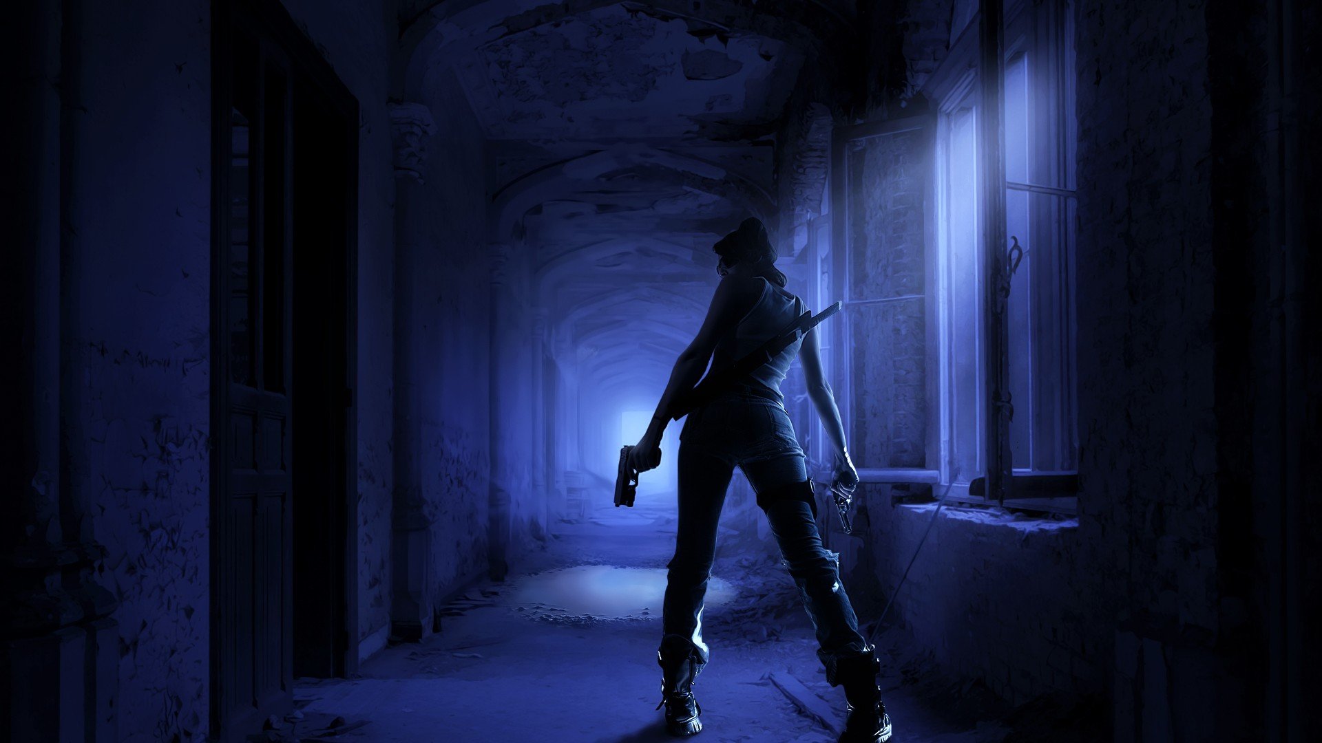 A fierce woman warrior stands poised in a dark, abandoned corridor, holding a gun, illuminated by eerie blue light in this HD fantasy wallpaper.