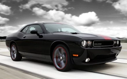 A sleek black Dodge Charger on an open road, set against a dramatic cloudy backdrop, serves as an eye-catching HD PC desktop wallpaper and background.