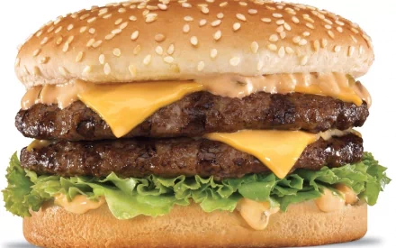An appetizing burger featuring two beef patties, cheddar cheese, lettuce, and a rich sauce, displayed as a high-definition desktop wallpaper.