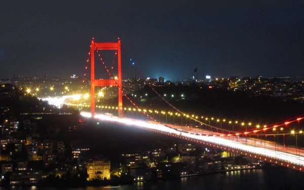 2K Quad HD PC desktop wallpaper: night view of the man-made Bosphorus Bridge illuminated with light trails stretching across the city.